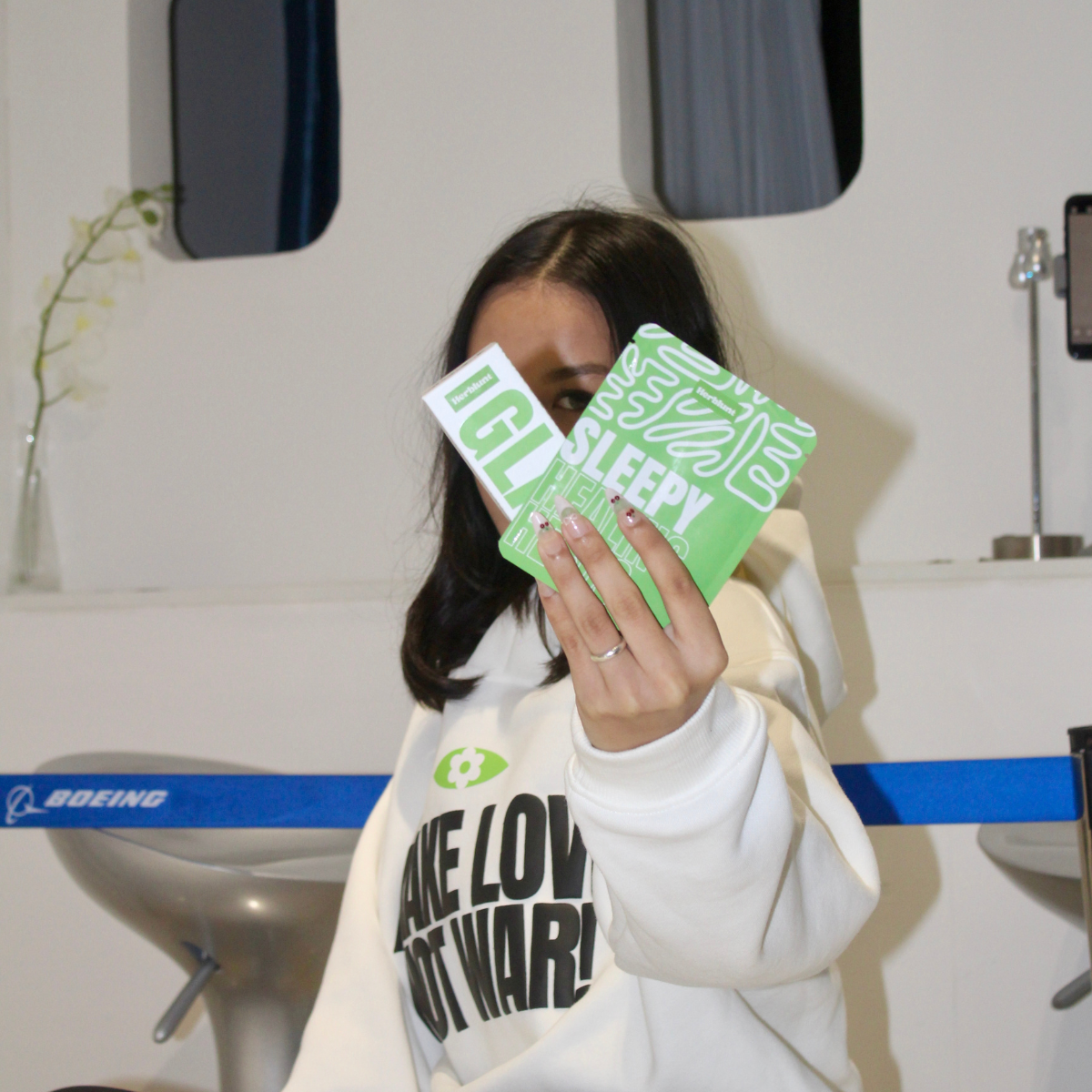 Person showing herblunt sleepy herbal blend and glass pipe